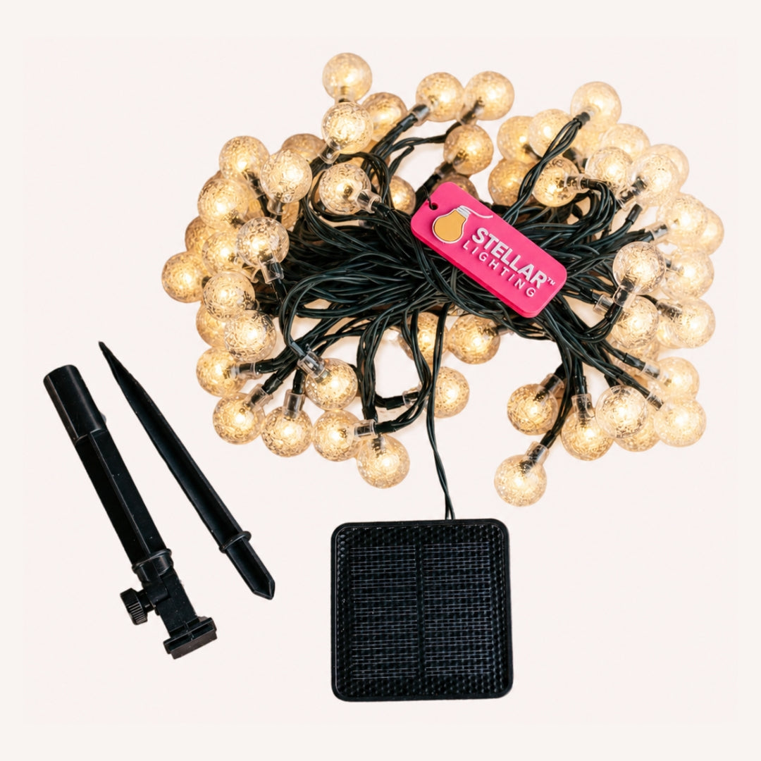 60 LED solar bubble light string coiled on off white background