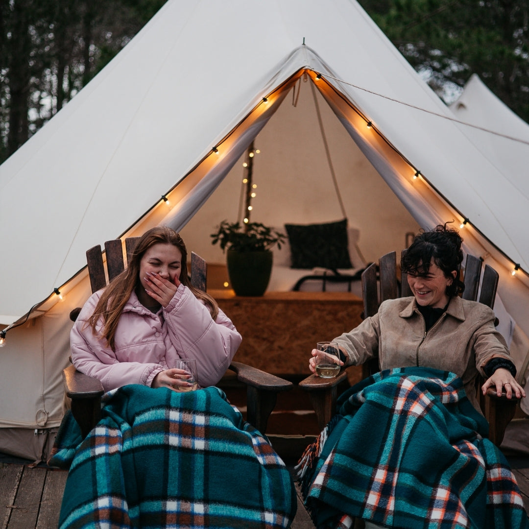 Solar Classic String Lights with warm white G40 globe bulbs strung around a camping or glamping tent in a South African outdoor setting powered entirely by solar energy