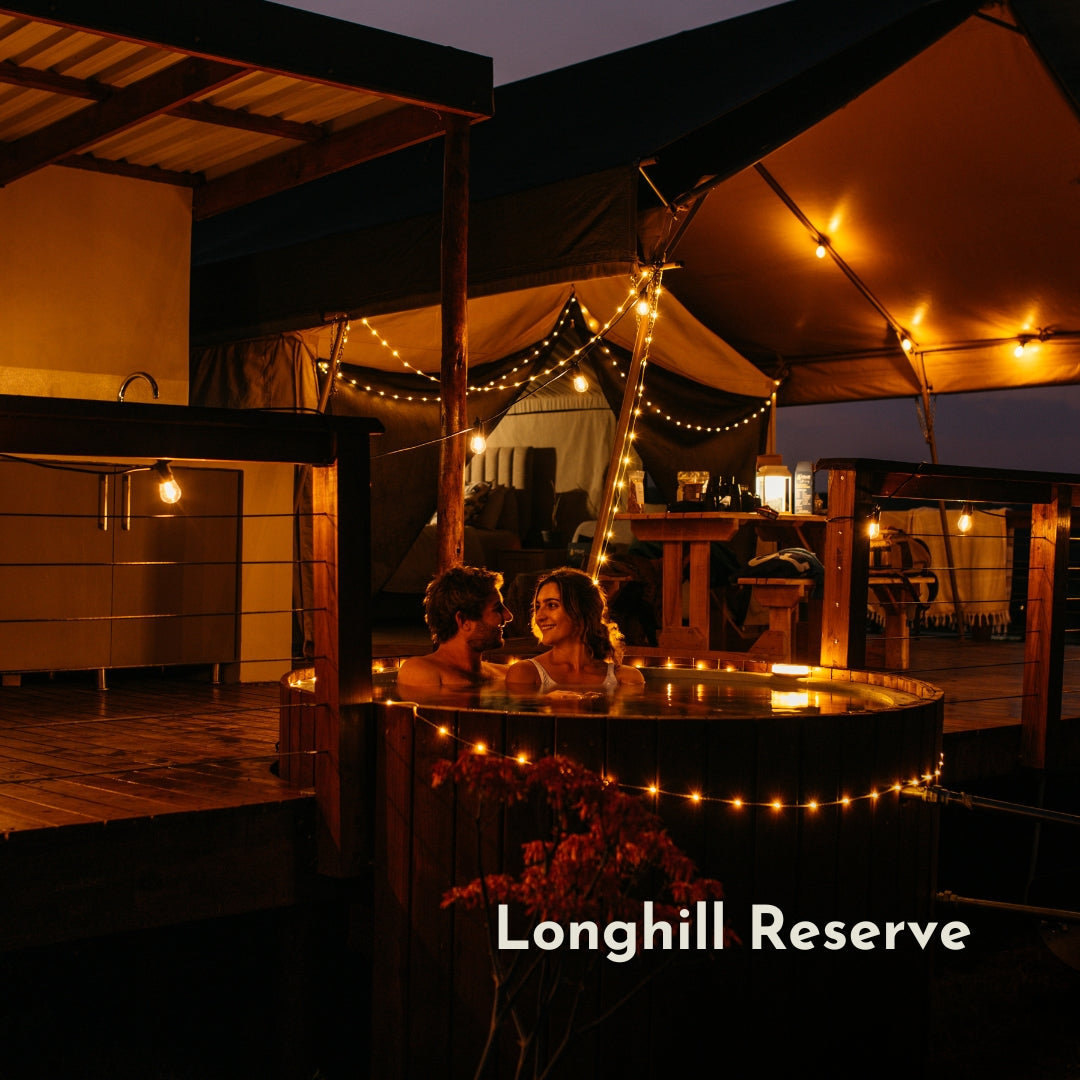 Solar Festoon String Lights with warm white S14 vintage LED bulbs strung across a South African glamping setting at dusk powered by solar energy