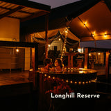 Solar Festoon String Lights with warm white S14 vintage LED bulbs strung across a South African glamping setting at dusk powered by solar energy