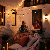 Solar Festoon String Lights with warm white S14 vintage LED bulbs strung across a South African outdoor patio or garden at dusk powered entirely by solar energy
