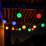 String lights with multicolored bulbs hanging against a dark background