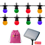Colourful solar string lights with a pink drawstring bag and solar panel on a white background