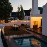 South African garden in the evening glowing with 100 warm white LEDs from Ultimate Dark Green Fairy Lights