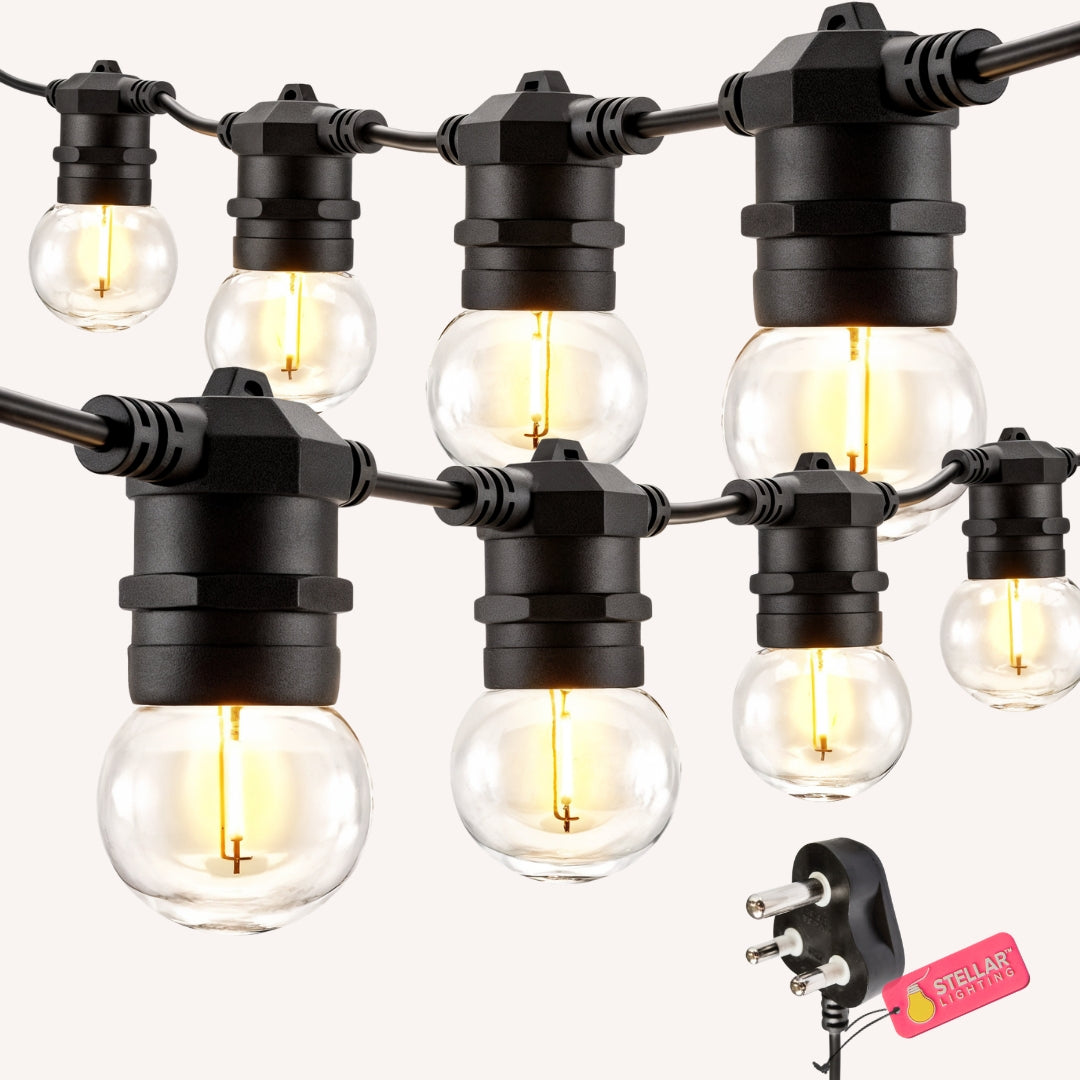 Ultimate Festoon String Lights flat lay showing warm white G45 retro globe bulbs on black heavy duty cable with South African plug on a light background
