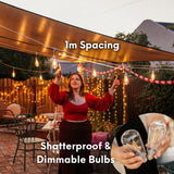 Outdoor dining scene under Ultimate White Drop String Lights with 1m spacing callout and inset showing warm white ST64 LED bulb suspended on individual drop wire