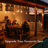 Ultimate White Drop String Lights suspended on individual drop wires across a South African garden at night with outdoor dining table set for dinner, braai area, and pool reflecting warm light in the foreground