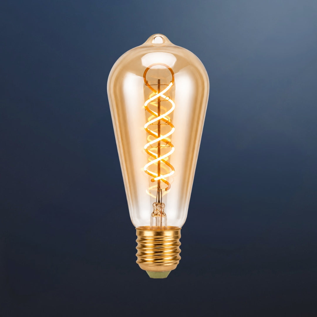 Single ST64 vintage LED bulb with golden spiral filament and amber tinted glass on a dark navy background
