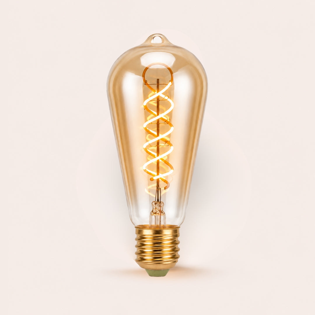 Single ST64 vintage LED bulb with golden spiral filament and amber tinted glass on a light background