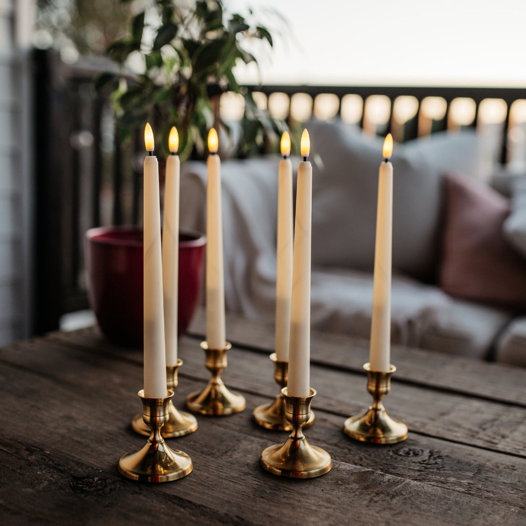 Set of six ivory flameless LED taper candles with warm amber flicker