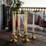 Set of six ivory flameless LED taper candles with warm amber flicker