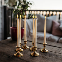 Set of six ivory flameless LED taper candles with warm amber flicker