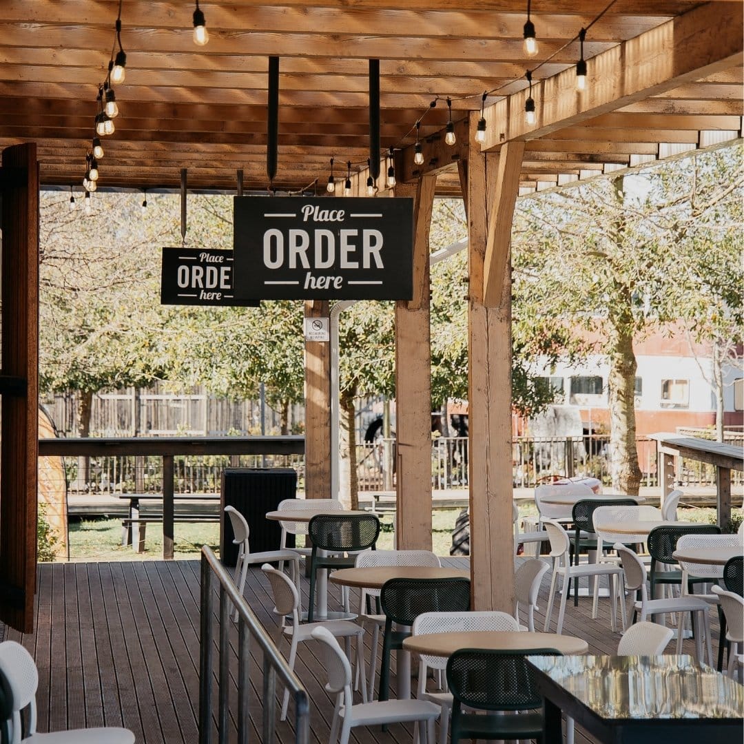 Outdoor Ambiance with Festoon Drop String Lights at Peregrine Vintage-style festoon bulbs glowing softly at dusk at Peregrine café area