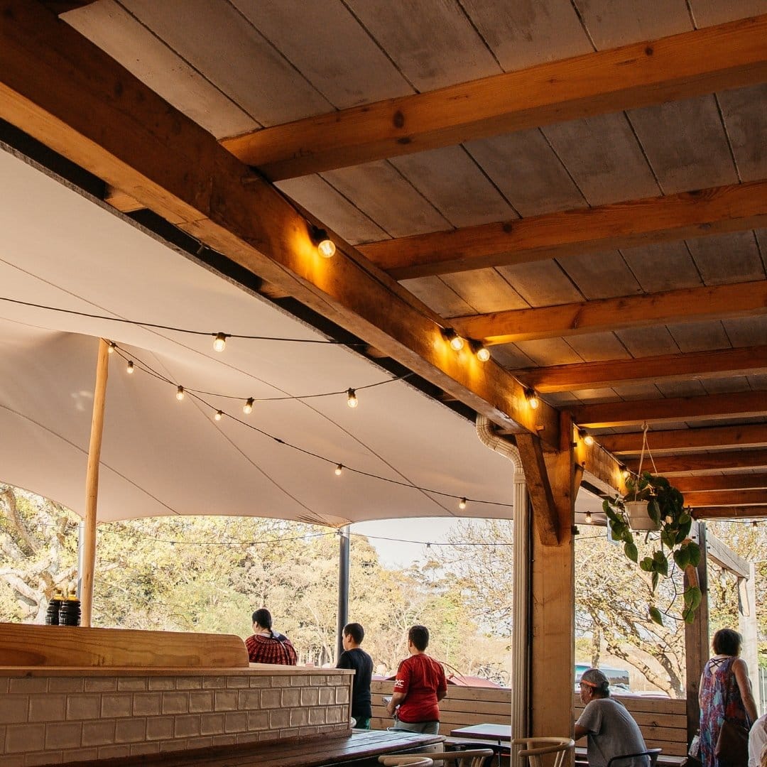 20 m Retro Festoon Lights at Peregrine Farm Stall Retro-style festoon bulbs draped between pergolas at Peregrine outdoor seating