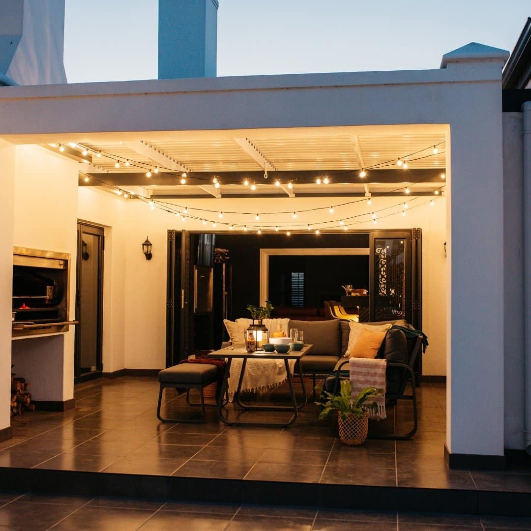 Outdoor black string lights with 25 warm LED bulbs creating a soft glow over a patio at night