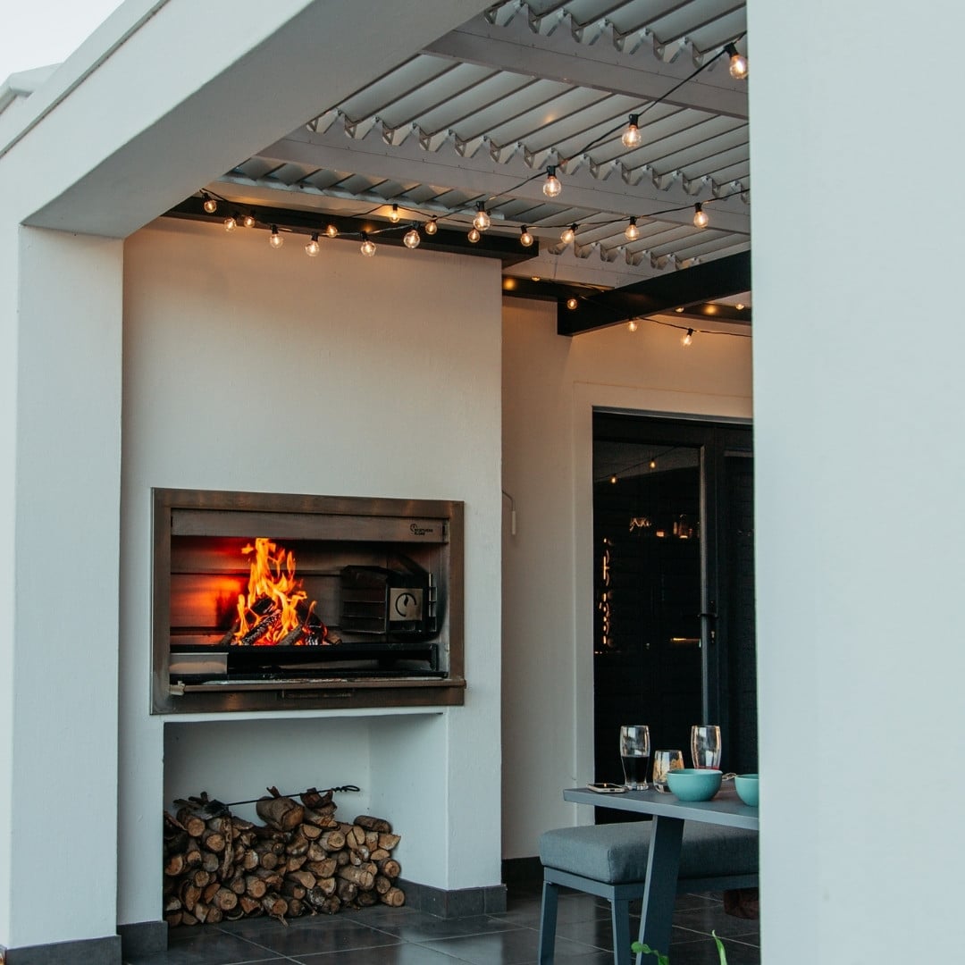 Outdoor black string lights with 25 warm LED bulbs creating a soft glow over a patio at night