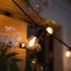 Warm white solar festoon string lights creating a cosy outdoor glow.