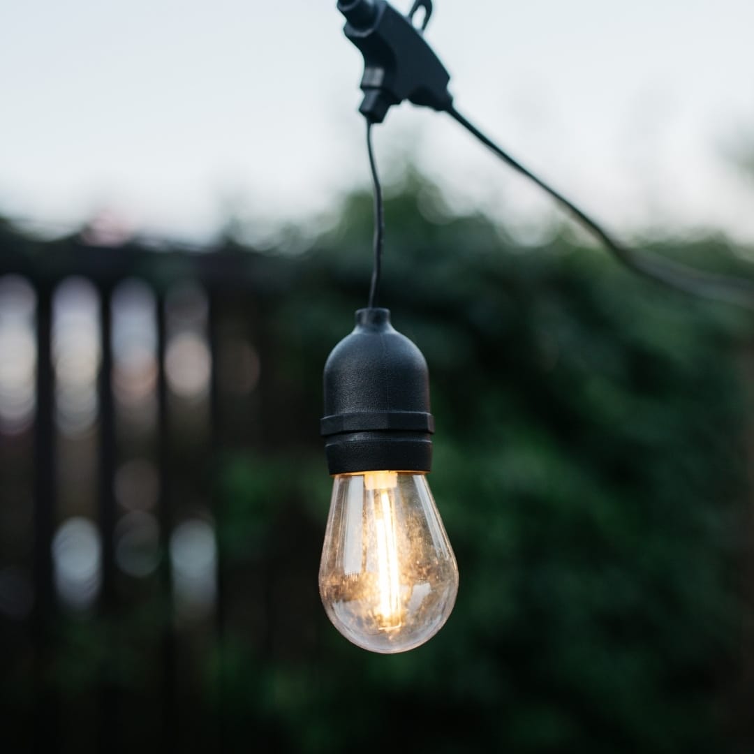 Stellar Lighting Drop String Lights with warm white S14 bulbs on a black cable, 10 metres in length