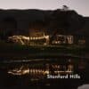 Stellar Drop String Lights installed across a restaurant terrace or outdoor venue, casting warm ambient light at dusk