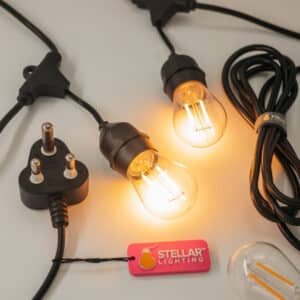 Flat lay of Stellar Drop String Lights showing the coiled cable, S14 bulbs, and packaging for the bulb 10m set