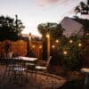 Stellar Drop String Lights strung across a home pergola or garden area, creating a warm glow for outdoor entertaining