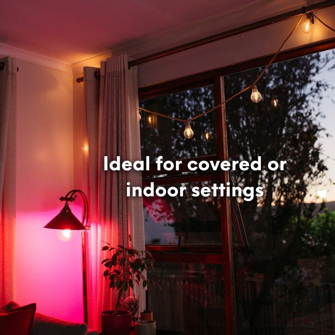 Solar powered cotton string lights hanging in a cosy covered patio creating a relaxed warm evening ambience.