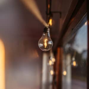 Solar powered cotton string lights hanging in a cosy covered patio creating a relaxed warm evening ambience.