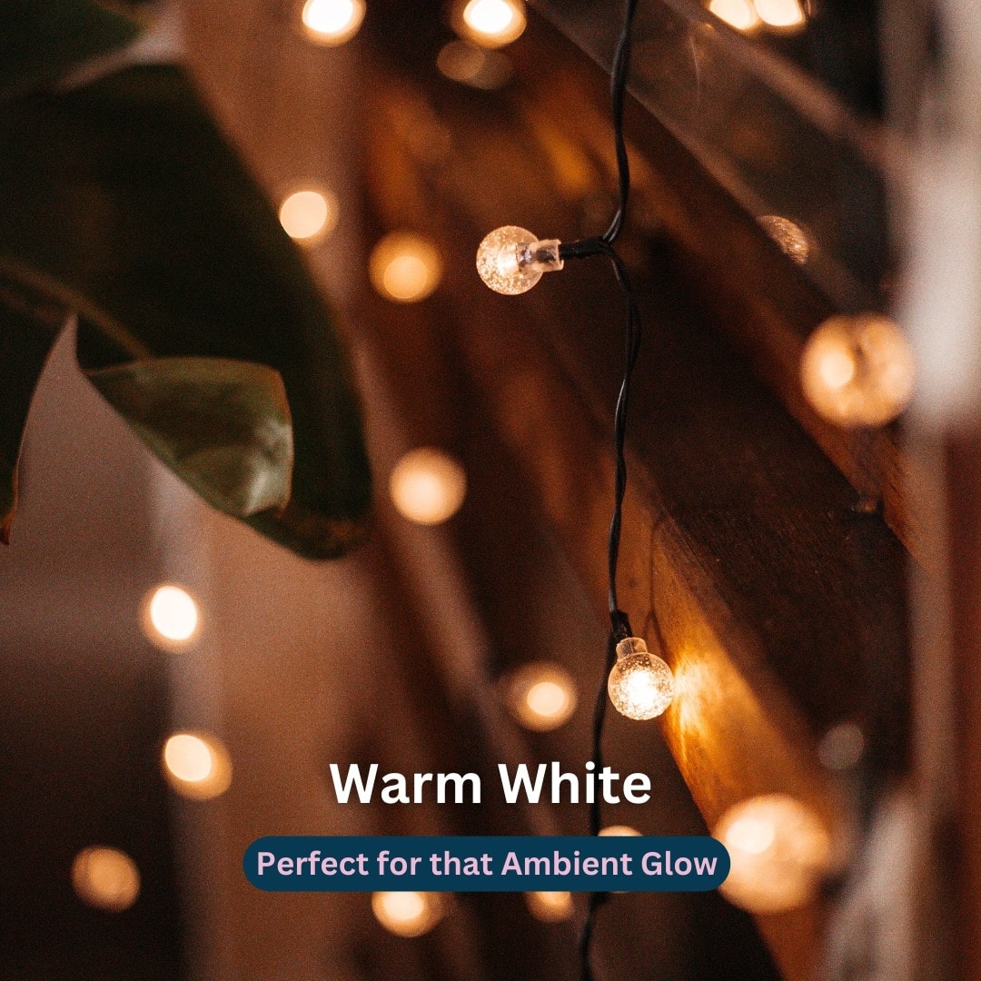 50 LED Solar Bubble Ball Fairy Lights glowing in an outdoor garden setting