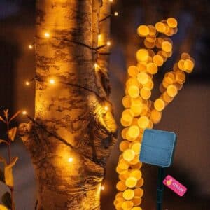 20m Solar Fairy Lights glowing in a garden setting