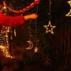 Moon and star curtain fairy lights with warm white glow in bedroom setting
