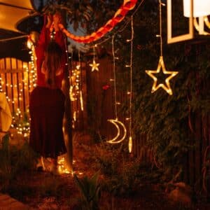 Moon and star curtain fairy lights with warm white glow in bedroom setting