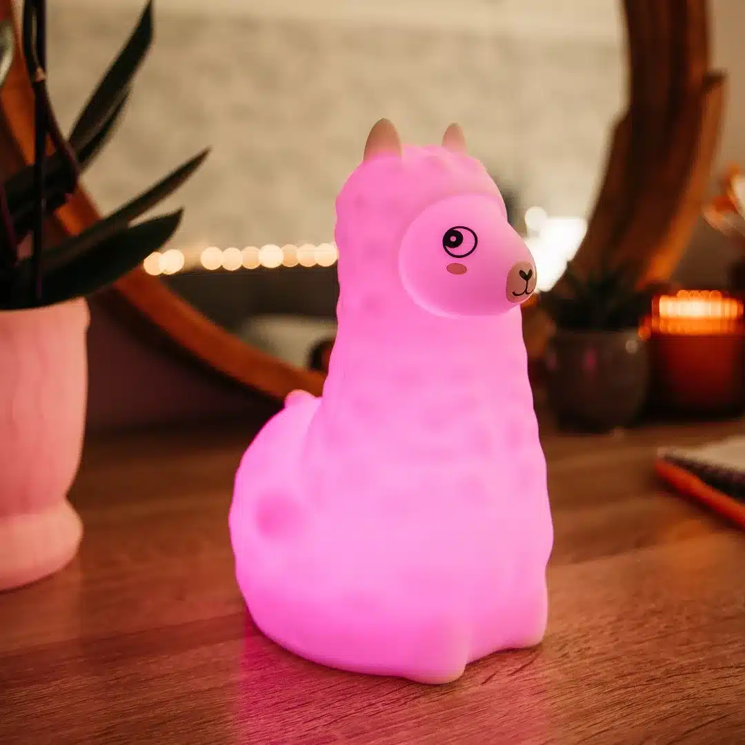 Stellar Lighting Rechargeable LED Kids LLAMA Night Light Llama-shaped night light standing on a bedside table
