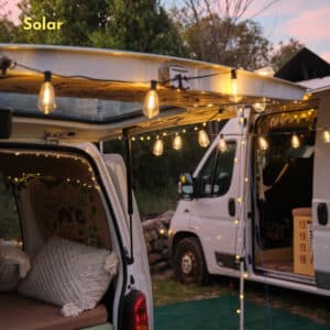 Solar-powered vintage LED string lights glowing at dusk in an outdoor setup