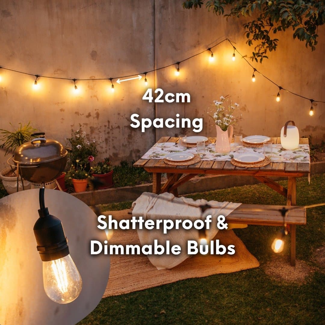 Dimmable and shatterproof 10m festoon string lights by Stellar Lighting creating a soft glow over a table setting outdoors.