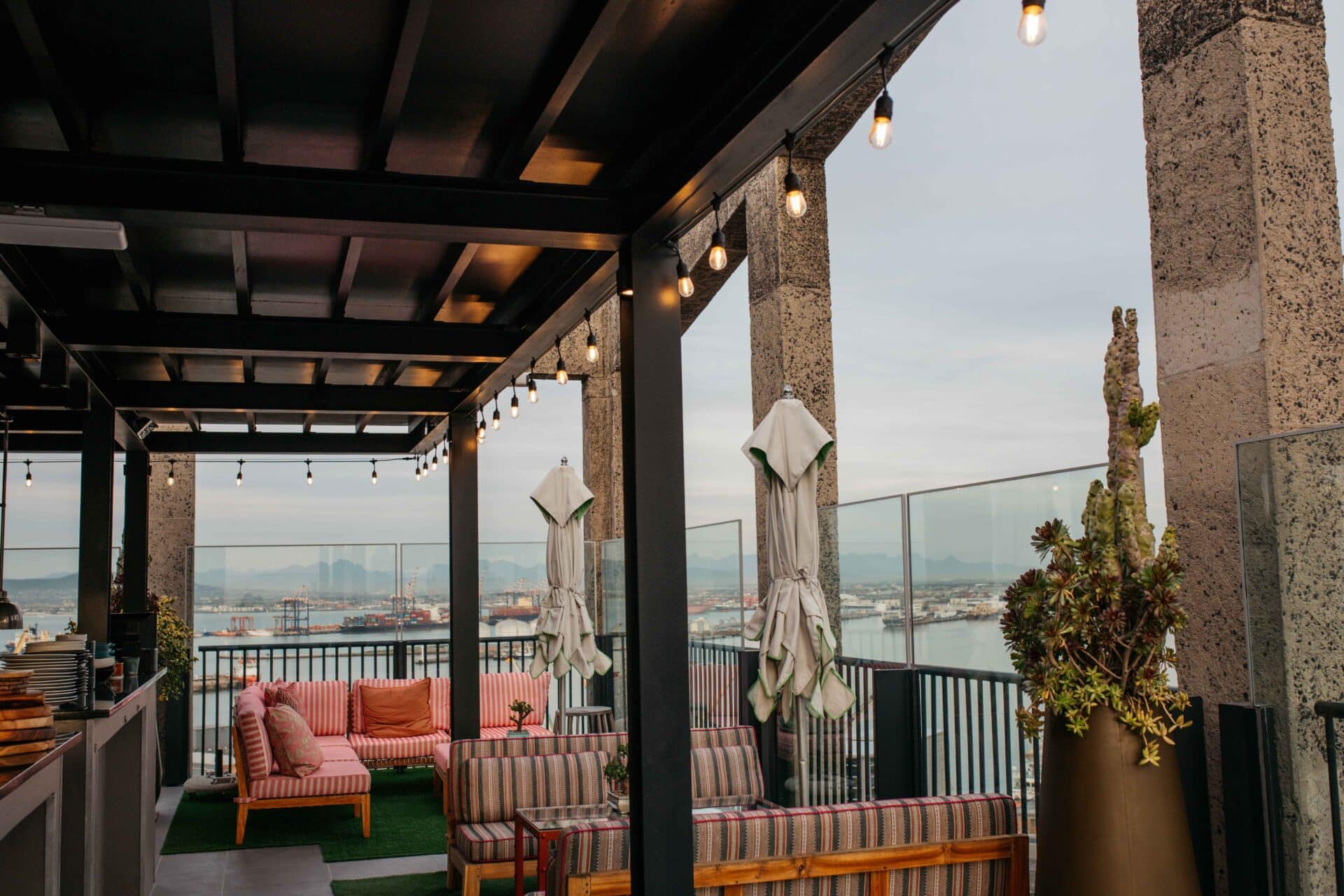 Warm white 10m plug-in festoon string lights by Stellar Lighting hanging over an outdoor dining area in South Africa.