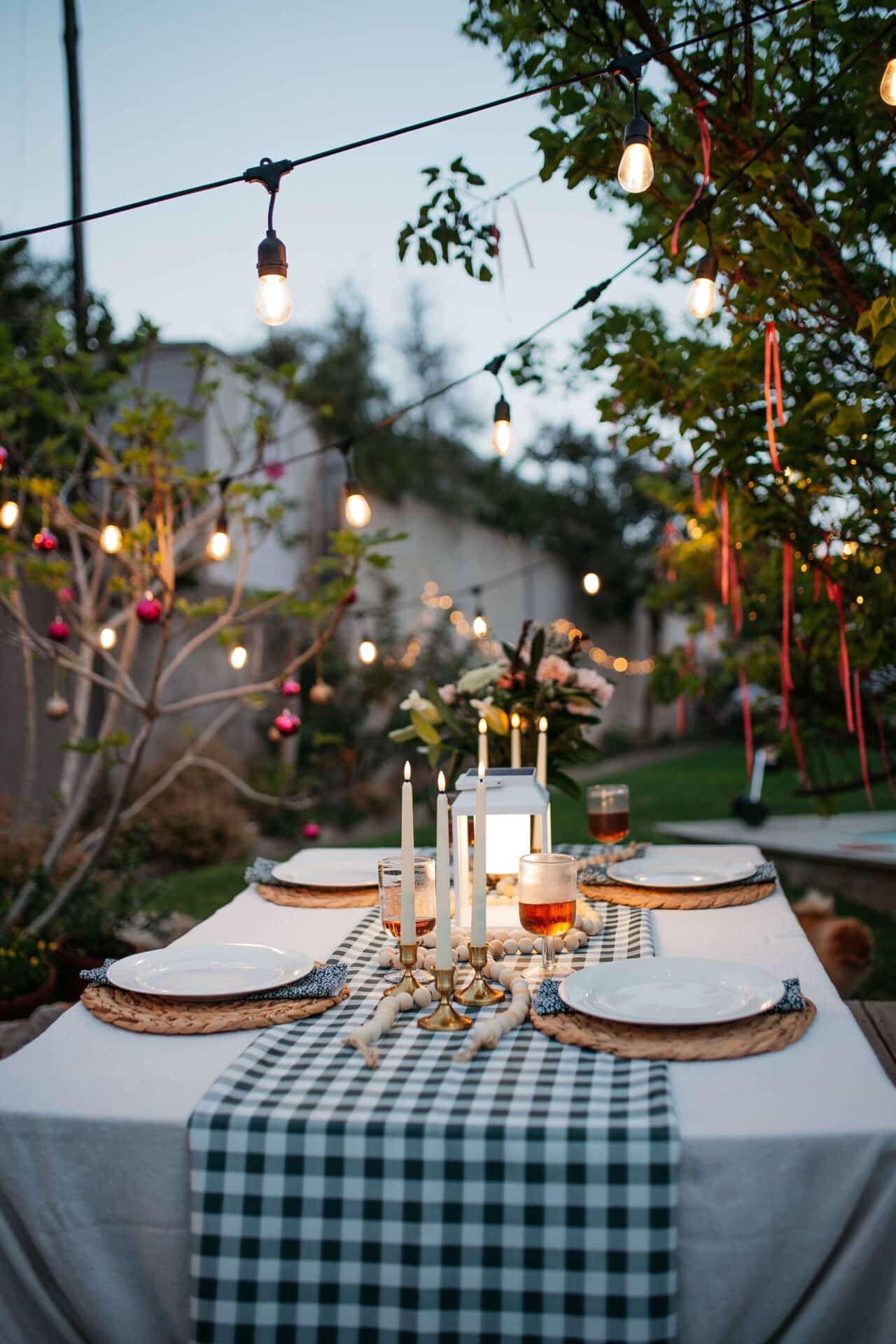 Warm white 10m plug-in festoon string lights by Stellar Lighting hanging over an outdoor dining area in South Africa.