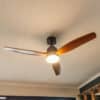 52-inch ceiling fan with light and remote control, featuring three dark brown oak blades.