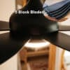 52-inch black ceiling fan with five sleek blades, remote control, and built-in light for efficient cooling and illumination.
