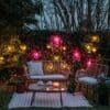 Four flamingo-pink LED bulbs with gold drop string lights styled for a warm indoor glow.
