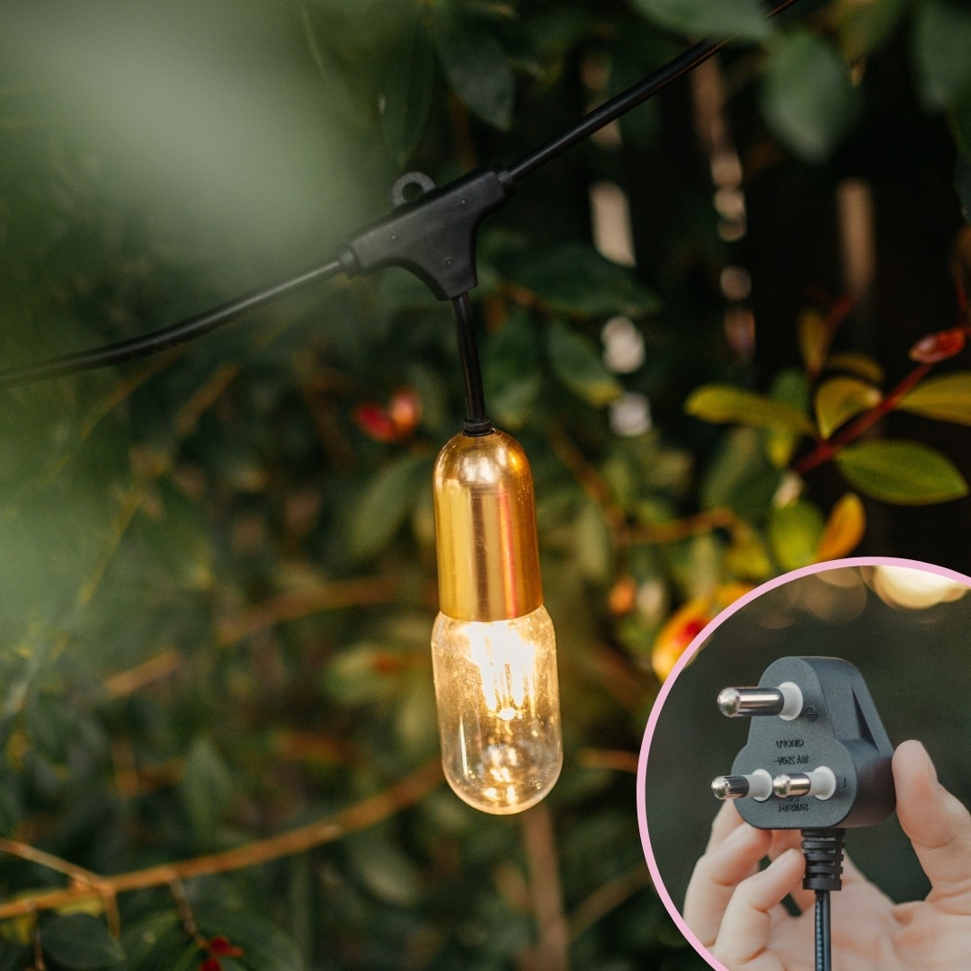 Four flamingo-pink LED bulbs with gold drop string lights styled for a warm indoor glow.