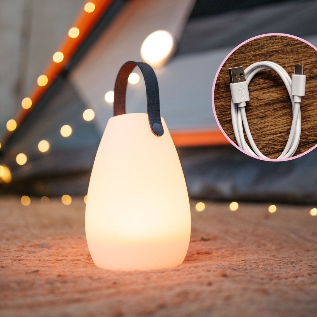 LED camping string light and rechargeable speaker lantern glowing in a cozy outdoor setting.