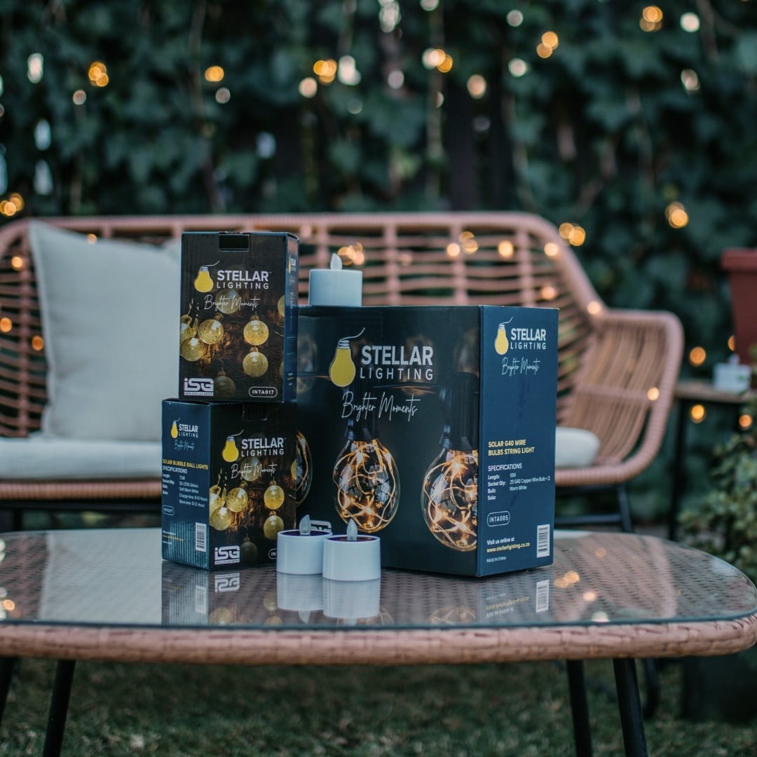 Romantic solar fairy lights, bubble lights, and flickering tea lights glowing under a tree.