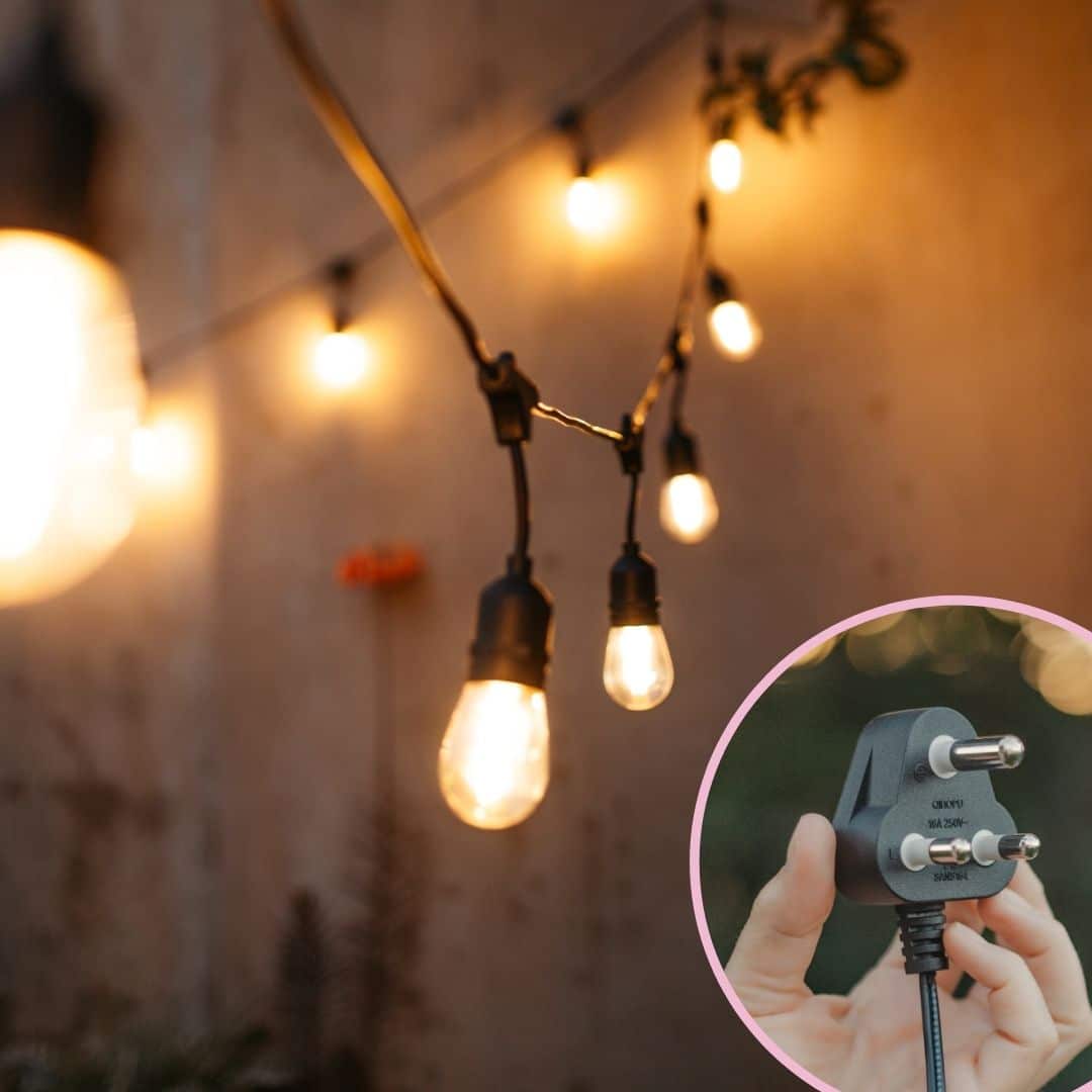 Outdoor string lights and speaker lantern illuminating a braai area at dusk.