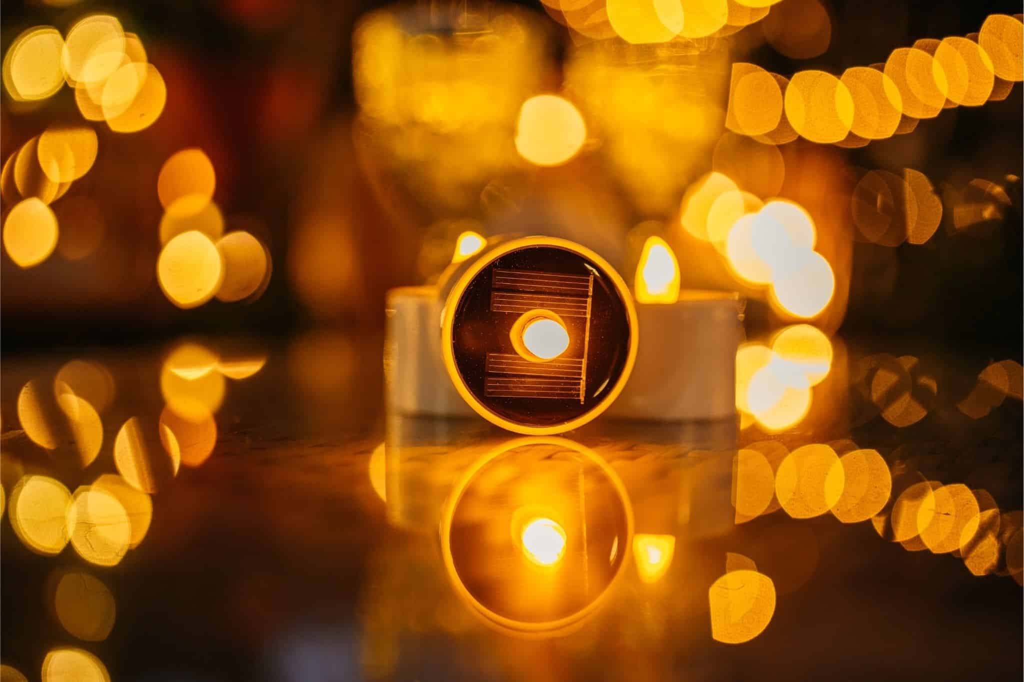 Romantic solar fairy lights, bubble lights, and flickering tea lights glowing under a tree.
