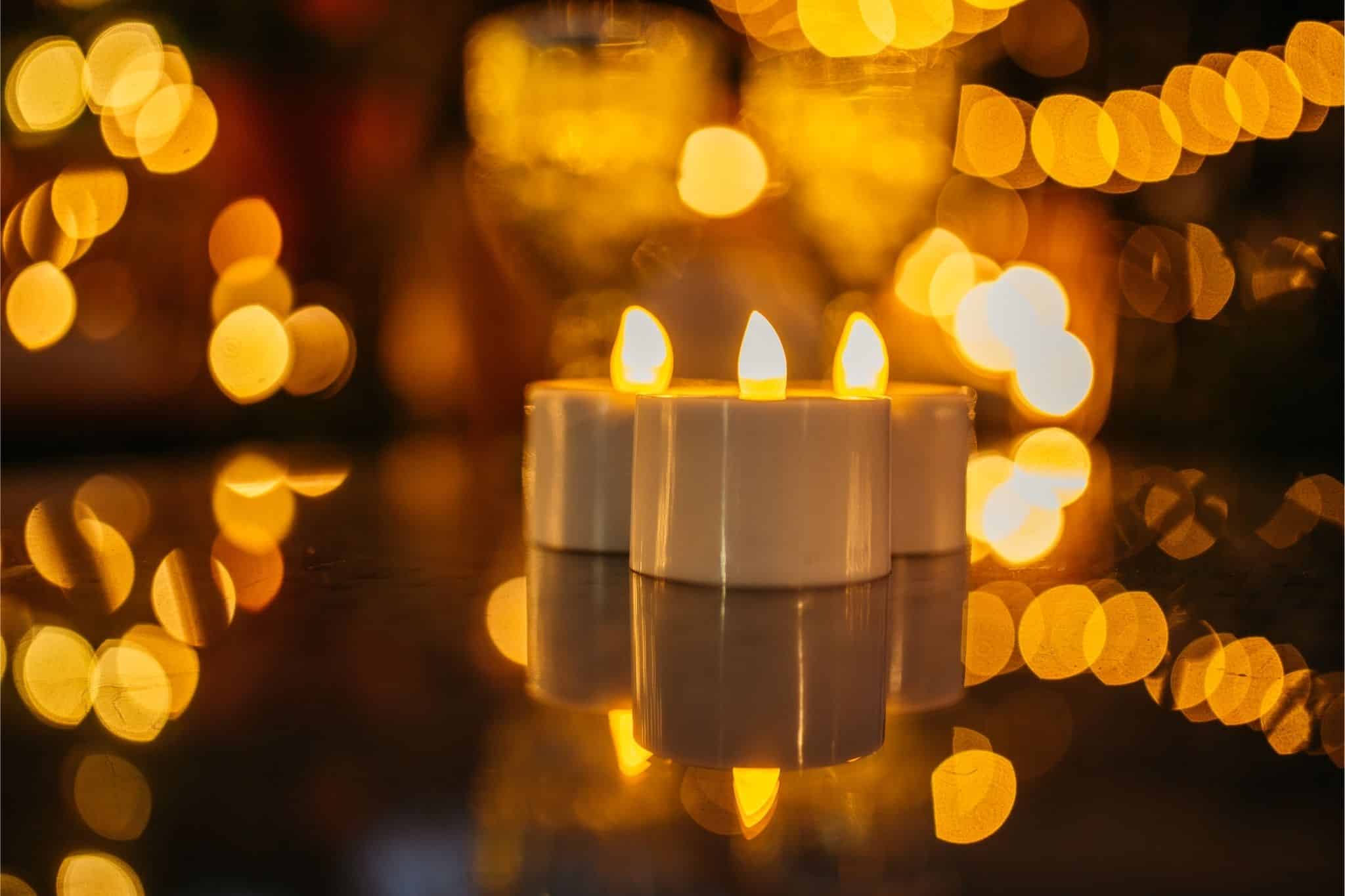 Romantic solar fairy lights, bubble lights, and flickering tea lights glowing under a tree.