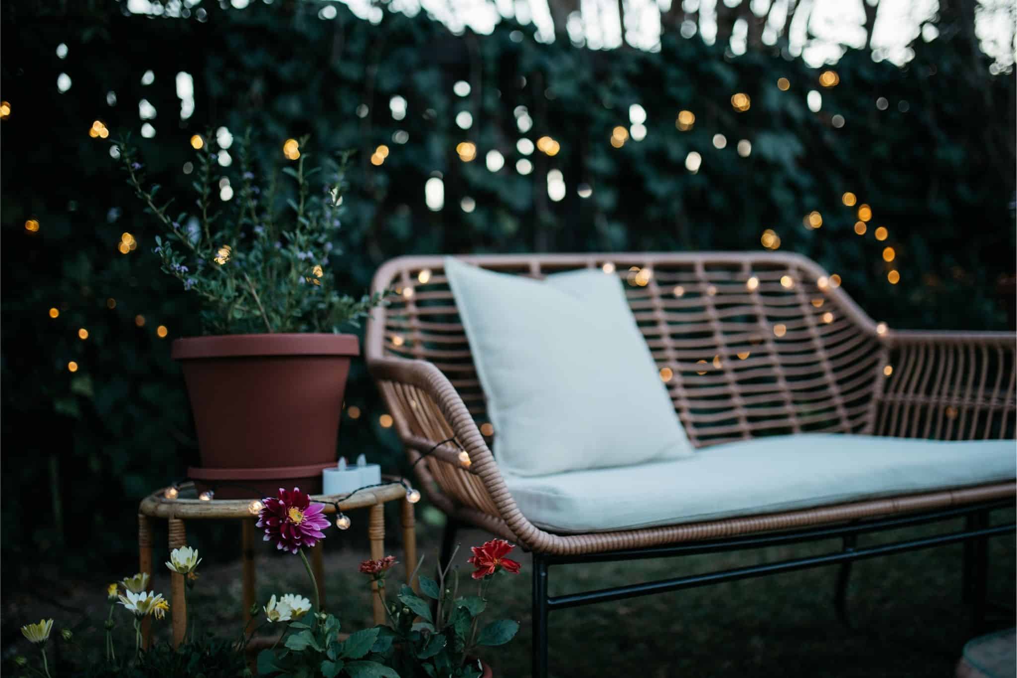 Romantic solar fairy lights, bubble lights, and flickering tea lights glowing under a tree.