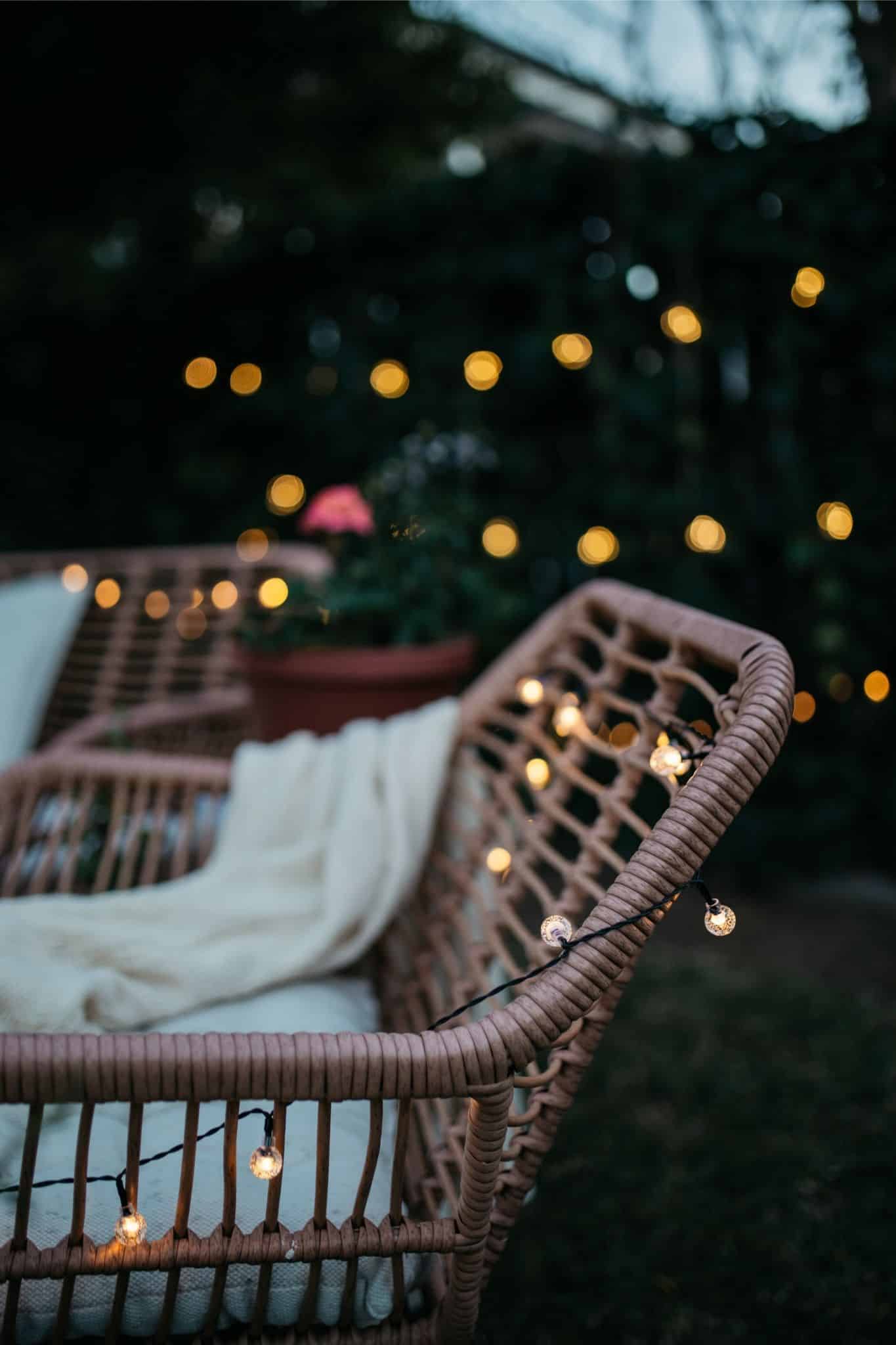 Romantic solar fairy lights, bubble lights, and flickering tea lights glowing under a tree.