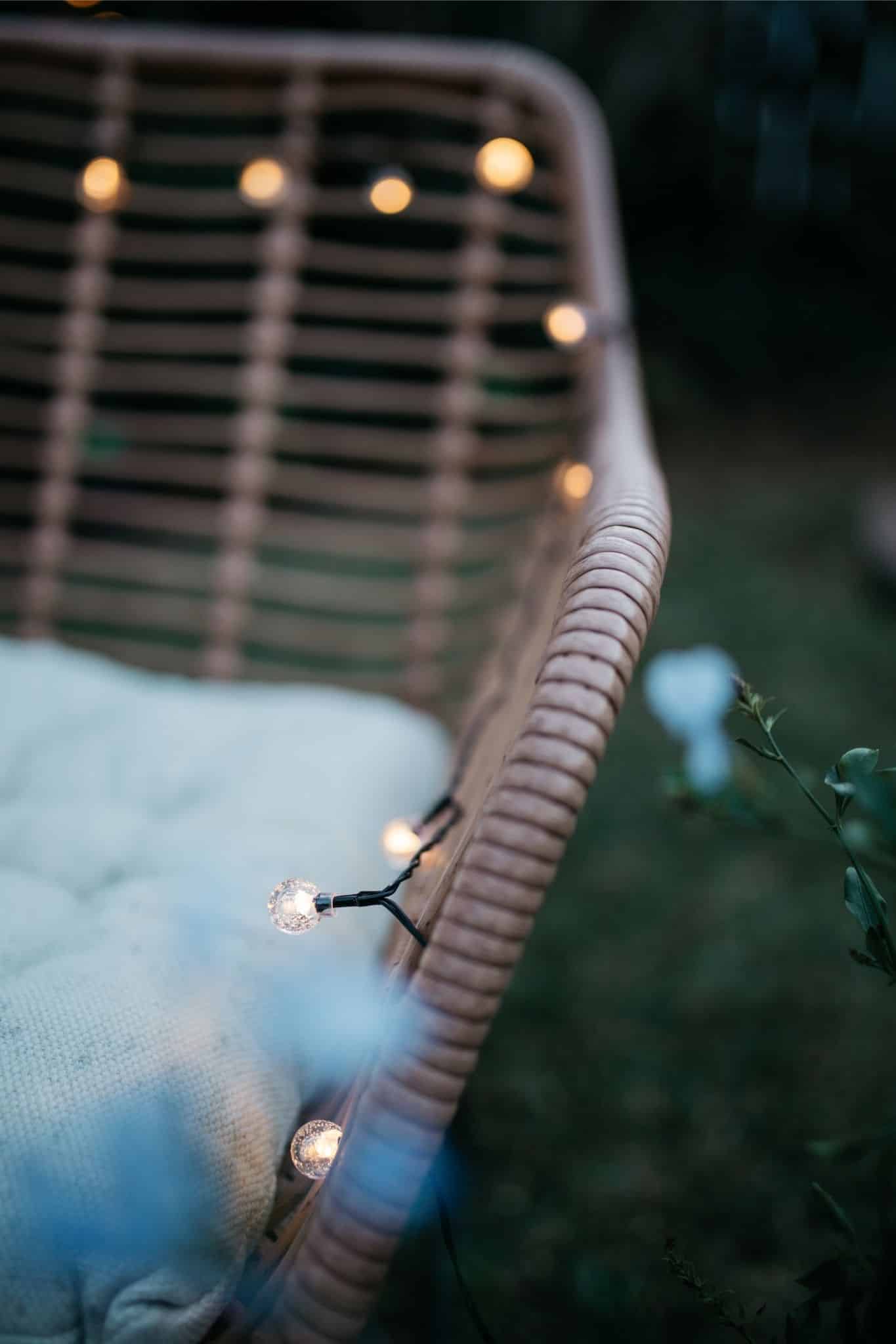 Romantic solar fairy lights, bubble lights, and flickering tea lights glowing under a tree.