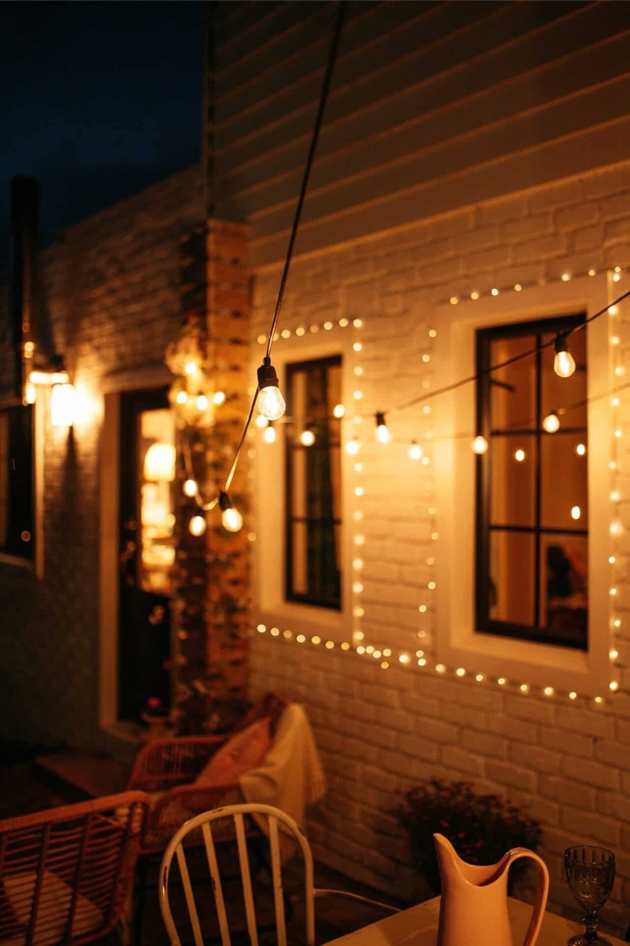 Warm white solar festoon string lights creating a cosy outdoor glow.