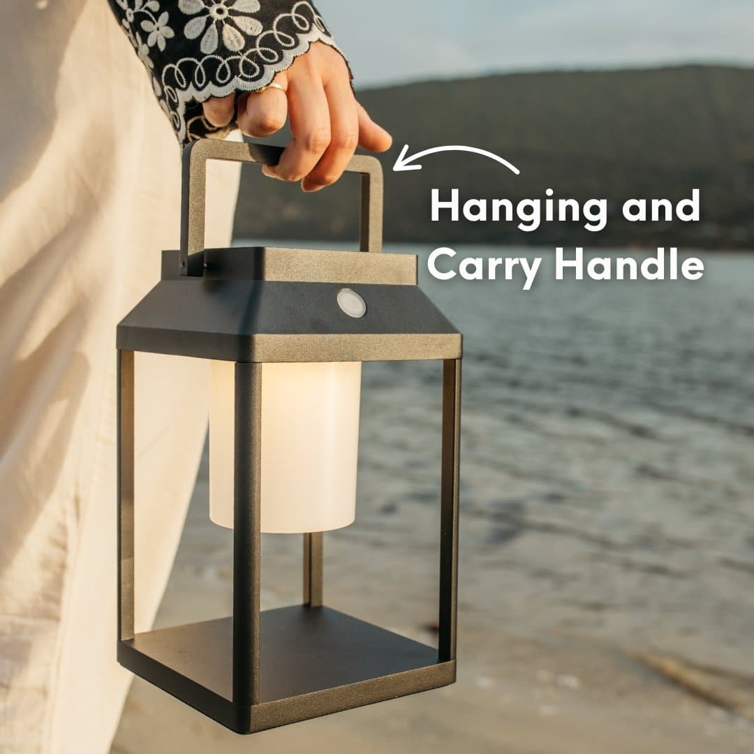 Black solar LED lantern mounted on outdoor wall with soft glow